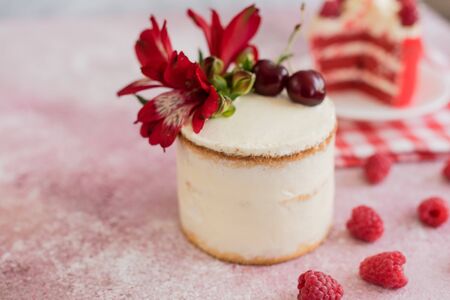 Beautiful pink cream and berries cake on a light concrete background. Birthday celebrationの写真素材