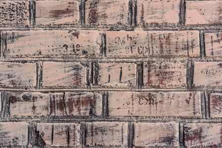 Texture of a brick wall with cracks and scratches which can be used as a background
