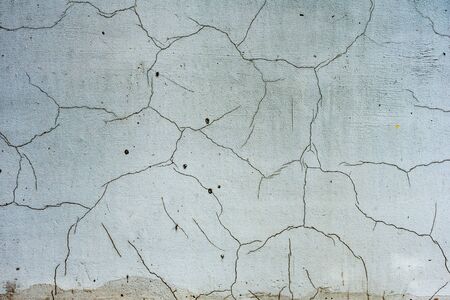 Texture of a concrete wall with cracks and scratches which can be used as a background