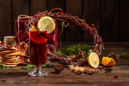Christmas hot mulled wine with cinnamon cardamom and anise on wooden backgroundの写真素材