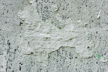 Texture of a concrete wall with cracks and scratches which can be used as a backgroundの写真素材