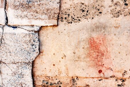 Texture of a brick wall with cracks and scratches which can be used as a background