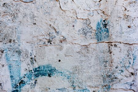Texture of a concrete wall with cracks and scratches which can be used as a background