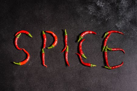 Bright red chilli pepper on a grey concrete background. Spicy food, ingredients. This can be used as a backgroundの写真素材