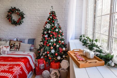 Christmas interior with gift boxes and Christmas fires. It can be used as a backgroundの写真素材