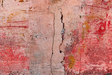 Texture of a concrete wall with cracks and scratches which can be used as a backgroundの写真素材