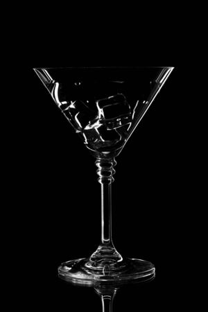 Silhouette of drinking glass on black background. Empty glass silhouette isolated on dark backgroundの写真素材