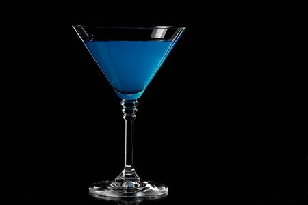 Close up of blue curacao drink. Blue lagoon cocktail in glass. Drink on a dark backgroundの写真素材