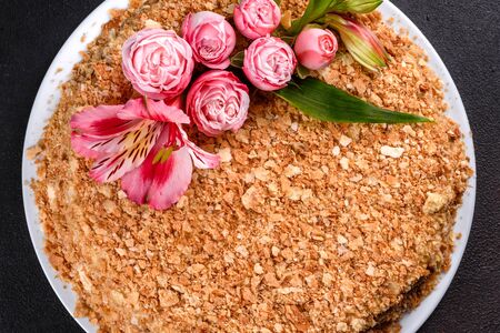 Fresh delicious cake napoleon with cream on a dark background. Cake consisting of cords and creamの写真素材