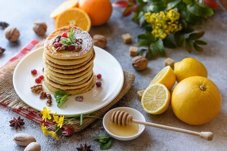 Delicious fresh beautiful pancakes with citrus honey and jam. Delicious hot breakfast with pancakes with fruit and berriesの写真素材
