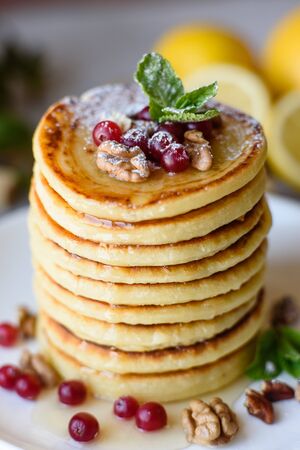 Delicious fresh beautiful pancakes with citrus honey and jam. Delicious hot breakfast with pancakes with fruit and berriesの写真素材