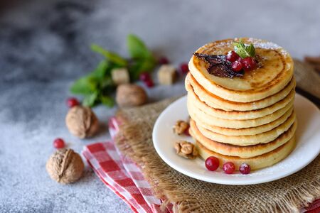 Delicious fresh beautiful pancakes with citrus honey and jam. Delicious hot breakfast with pancakes with fruit and berriesの写真素材