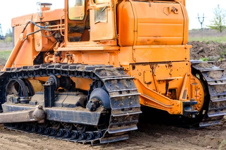 Industrial building construction site bulldozer leveling and moving soil during highway building....