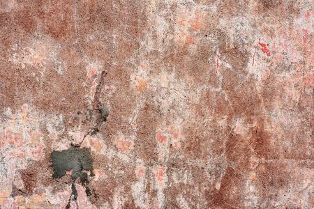 Texture of a concrete wall with cracks and scratches which can be used as a backgroundの写真素材