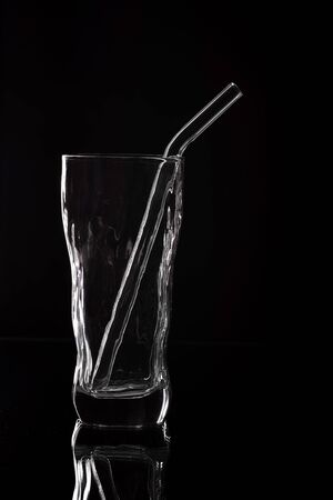 Silhouette of drinking glass on black background. Empty glass silhouette isolated on dark backgroundの写真素材