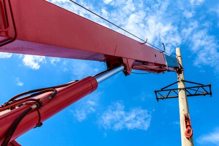 Installation of column for high-voltage electricity line against the background of blue sky on a...