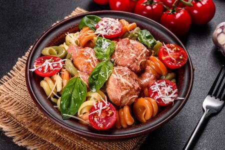 Delicious fresh pasta with meatballs, sauce, cherry tomatoes and basil. Italian Mediterranean cuisineの写真素材
