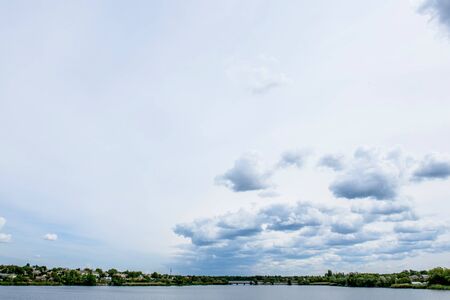 Dramatic summer sky with clouds at sunset. It can be used as a backgroundの写真素材