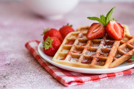 Delicious fresh baked belgian waffles with berries and fruit on a concrete backgroundの写真素材