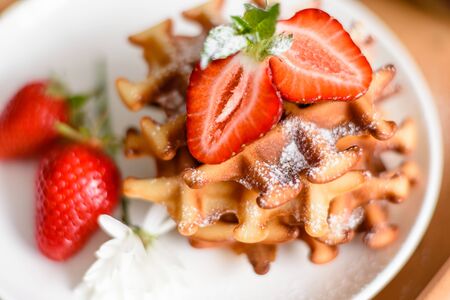 Delicious fresh baked belgian waffles with berries and fruit on a concrete backgroundの写真素材