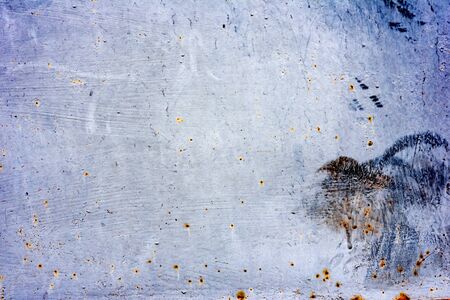Texture of a metal wall with cracks and scratches which can be used as a backgroundの写真素材