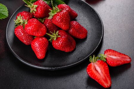 Fresh juicy strawberries with leaves. Fresh summer crop of strawberry berriesの写真素材