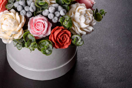 Bouquet of beautiful bright rose flowers in a gift cylindrical cardboard box. Gift bouquet of soap...