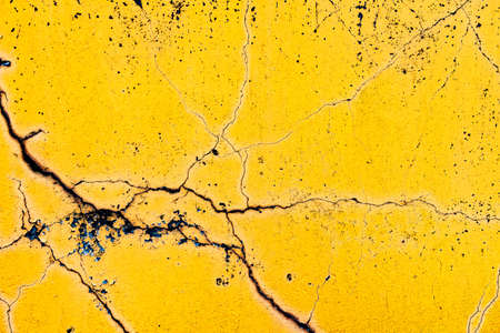 Old cracked painted yellow or orange wall