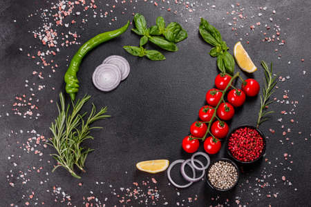 Fresh fish seabass and ingredients for cooking. Raw fish seabass with spices and herbs on a dark...