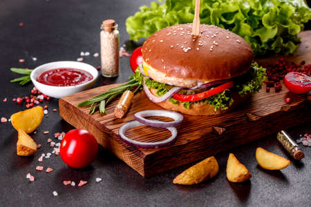 Home made hamburger with lettuce and cheese. Close-up of home made tasty burgers on wooden tableの写真素材