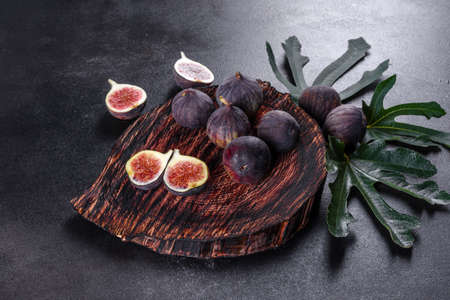 Fresh ripe figs on dark table. Healthy mediterranean fig fruit. Fresh figs on black background