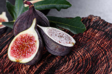 Fresh ripe figs on dark table. Healthy mediterranean fig fruit. Fresh figs on black background