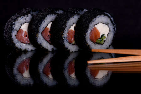 Fresh delicious beautiful sushi rolls on a dark background. Elements of Japanese cuisineの写真素材