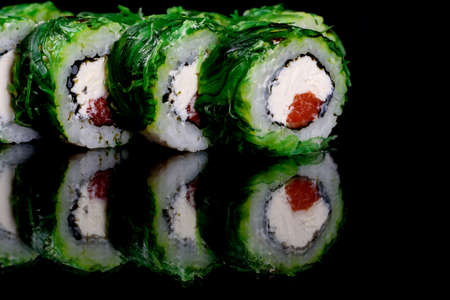 Fresh delicious beautiful sushi rolls on a dark background. Elements of Japanese cuisineの写真素材