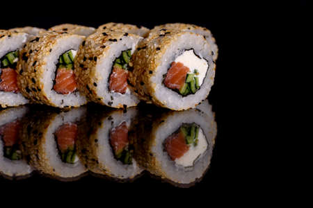Fresh delicious beautiful sushi rolls on a dark background. Elements of Japanese cuisineの写真素材