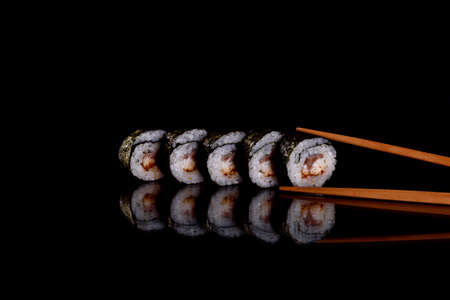 Fresh delicious beautiful sushi rolls on a dark background. Elements of Japanese cuisineの写真素材