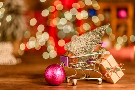 Shopping cart with Christmas gifts and presents. Christmas shopping and sale conceptの写真素材