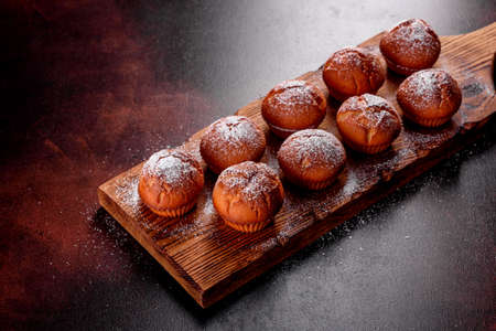 Beautiful delicious fresh cocoa muffins on the table. Preparing for the holiday