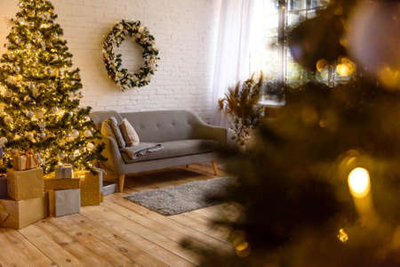 Beautiful holdiay decorated room with Christmas tree with presents under it. New year backgroundの写真素材