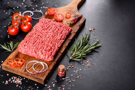 Fresh raw beef mince on a dark background. Preparation for cooking of cutletsの写真素材