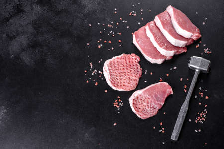 A fresh raw piece of pork escalop cut into several parts. Preparing Meat for Roastingの写真素材