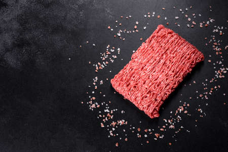 Fresh raw beef mince on a dark background. Preparation for cooking of cutletsの写真素材