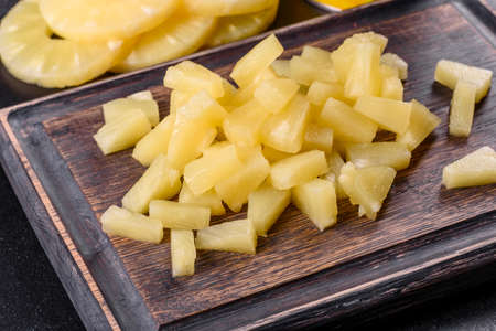Pineapple canned with pieces on a wooden cutting board. Cooking Ingredientsの写真素材