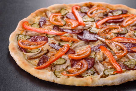 Fresh delicious pizza made in a hearth oven with sausage, pepper and tomatoes. Mediterranean cuisineの写真素材