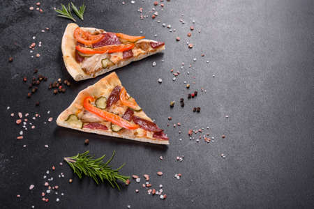 Fresh delicious pizza made in a hearth oven with sausage, pepper and tomatoes. Mediterranean cuisineの写真素材