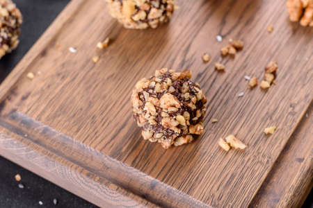 Tasty fresh handmade sweet candy with cheese filling and sprinkling on a concrete table