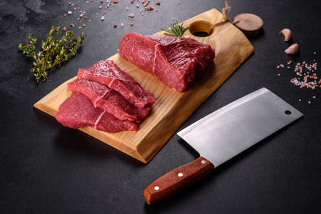 Fresh raw beef meat to make delicious juicy steak with spices and herbs. Preparation for grilled meatの写真素材