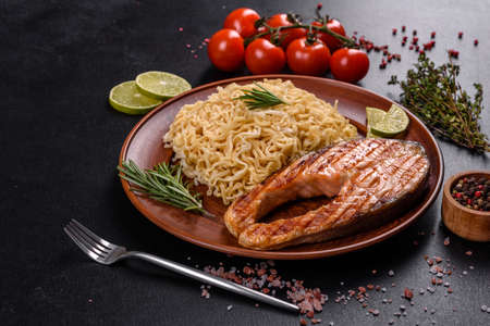 Fresh cooked delicious salmon steak with spices and herbs baked on a grill. Healthy seafood foodの写真素材