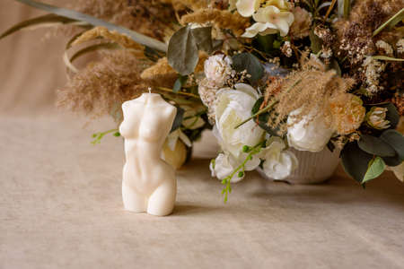 Beautiful candle in the shape of a human body to create the atmosphere of a romantic eveningの写真素材