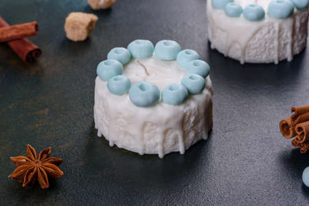 Beautiful colorful bright candle made in the form of an appetizing cake. Aromatherapy, candle with...